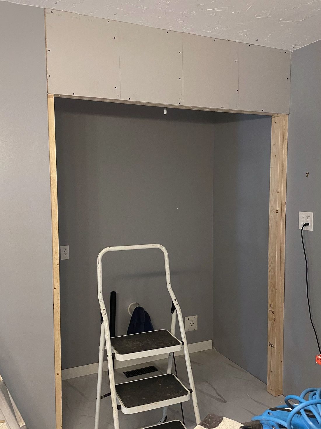 A closet opening framed in new lumber, with fresh sheetrock across the top.